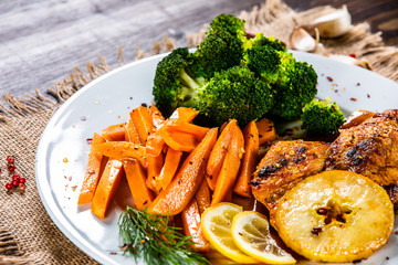 Grilled cgicken breast, French fries and vegetable salad