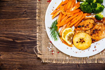 Grilled cgicken breast, French fries and vegetable salad