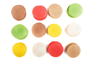 Macarons on a white background. Many colored macaroons top view.
