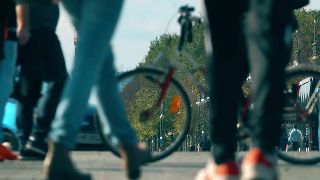 Telephoto lens shot of Berlin Victory Column and unknown walking people. Germany