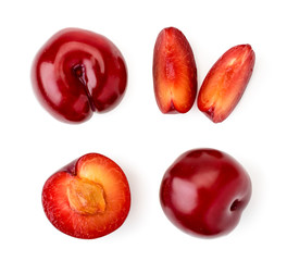 Set of red plums, half and pieces on a white. The view of the top.