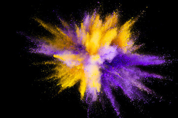 Colored powder explosion. Abstract closeup dust on backdrop. Colorful explode. Paint holi