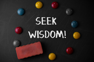 Word writing text Seek Wisdom. Business photo showcasing ability to think act using knowledge experience understanding Round Flat shape stones with one eraser stick to old chalk black board