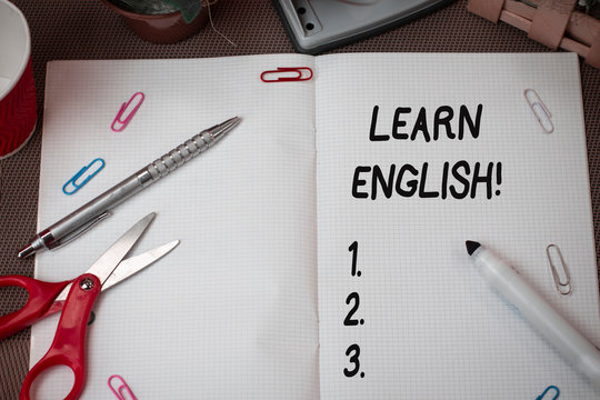 Text sign showing Learn English. Business photo showcasing gain acquire knowledge in new language by study Scissors and writing equipments plus math book above textured backdrop