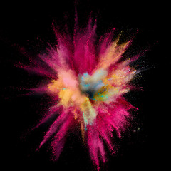 Colored powder explosion. Abstract closeup dust on backdrop. Colorful explode. Paint holi