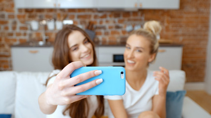 Two young girls making selfie at home.