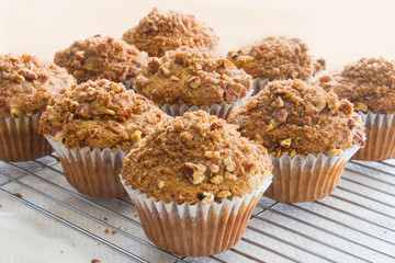 Freshly baked homemade muffins with a pecan crumble topping; Banana muffins with nuts and brown sugar on top