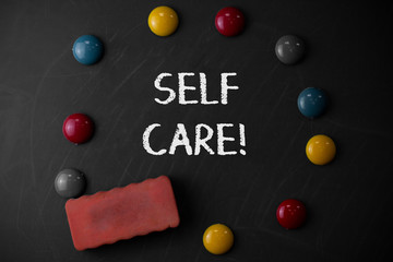 Word writing text Self Care. Business photo showcasing practice of taking action preserve or improve ones own health Round Flat shape stones with one eraser stick to old chalk black board
