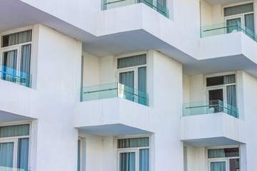 Fototapeta na wymiar living house building background of geometric shape white concrete wall with balcony and windows 