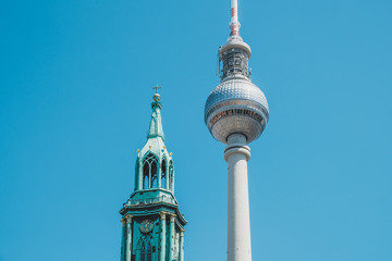 The Berlin Television tower (Fernsehturm) and Church St Mary in Berlin, Germany -
