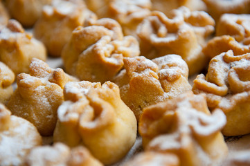 Homemade biscuit with violet hyacinth, white flower and yellow taraxacum on the wooden table