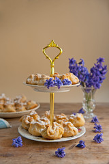 Homemade biscuit with violet hyacinth, white flower and yellow taraxacum on the wooden table