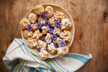 Homemade biscuit with violet hyacinth, white flower and yellow taraxacum on the wooden table