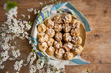 Homemade biscuit with violet hyacinth, white flower and yellow taraxacum on the wooden table