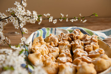 Homemade biscuit with violet hyacinth, white flower and yellow taraxacum on the wooden table