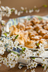 Homemade biscuit with violet hyacinth, white flower and yellow taraxacum on the wooden table