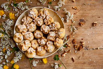 Homemade biscuit with violet hyacinth, white flower and yellow taraxacum on the wooden table