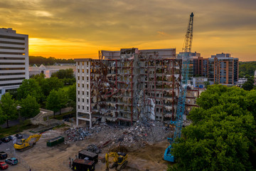 Aerial view of an office building under demolition by a wrecking ball in Columbia Town Center  Maryland new Washington DC 