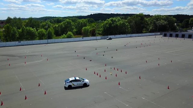 aerial view of police cars at the autodrome, asphalt autodrome with road markings driving exam, topl view of police turn at the autodrome