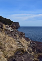 Fototapeta na wymiar rugged shoreline landscape along the East Coast trail, Stiles Cove Path near Flatrock Newfoundland Canada; early Spring 