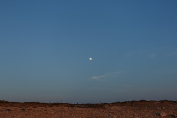 The moon in the sky. Before night It's getting dark. Minimalism in the photo. Place for advertising.