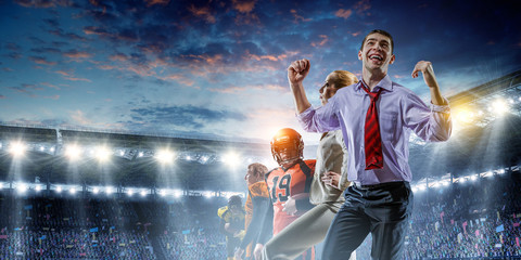 Business team on football stadium. Mixed media