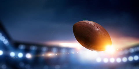 Night football arena in lights with a ball close up