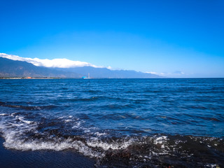 Blue Sea Water Wave Scenery Of Tropical Rocky Beach In The Clear Blue Sky On A Sunny Day At Umeanyar Village, North Bali, Indonesia