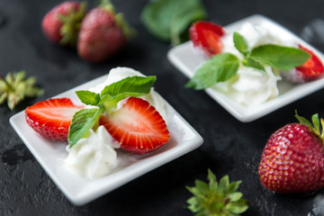 strawberries with cream and mint on a black background ,berries