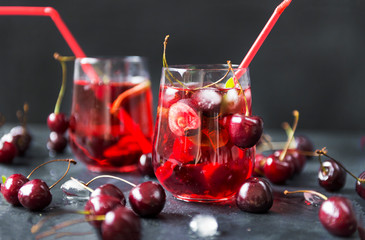 lemonade with cherries on black background