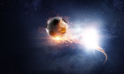Obraz na płótnie Canvas Soccer ball on fire and dark starry sky