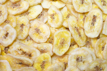 Background made of many dehydrated banana pieces, dried banana chips