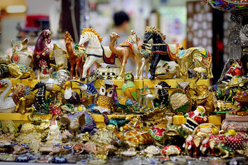Many different multicolored souvenir figurines in the shop, close-up