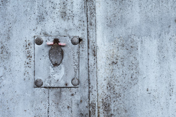 Rusty metal texture with covered keyhole, scratches and cracks. Paint traces. Blue, white and grey colors. Copy space