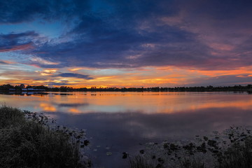 Obraz na płótnie Canvas Lake view morning scenic above lotus lake with cloudy sky background, sunrise at Krajub Reservoir, Ban Pong, Ratchaburi, Thailand.