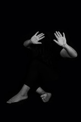 Victim with hands, victim of emotional stress and pain, abducted, abused, hostage, scared, restricted, trapped, may suffer, Stop violence and trafficking in women.