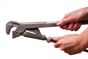 Obraz premium Girl holding a plumbing key isolated on a white background