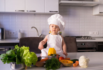  little boy, white chef hat, vegetables