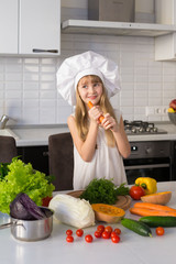  little girl, white chef hat, vegetables