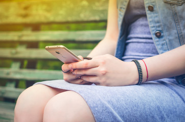 Girl texting on the phone in social networks.