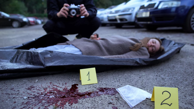 Bloody Female Corpse And Drugs Lying On Asphalt, Police Working On Crime Scene