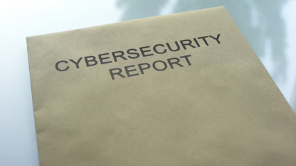 Cybersecurity report, folder with important documents lying on table, close up