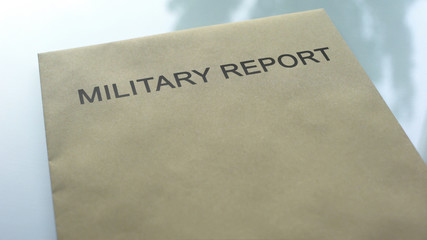 Military report, folder with important documents lying on table, close up