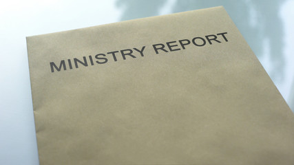 Ministry report, folder with important documents lying on table, close up