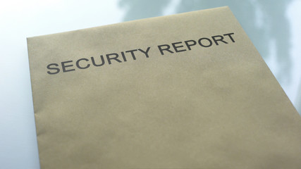 Security report, folder with important documents lying on table, close up