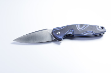 Knife in the center of the frame on a gray background. Pocket knife on a gray background.