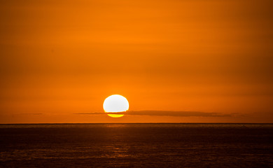 Sunset in Hawaii with a thin sliver of clouds on horizen 