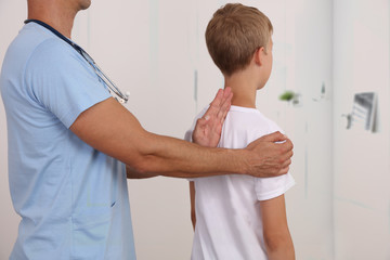 Child having chiropractic back adjustment. Osteopathy, Physiotherapy, Kinesiology. Bad posture...