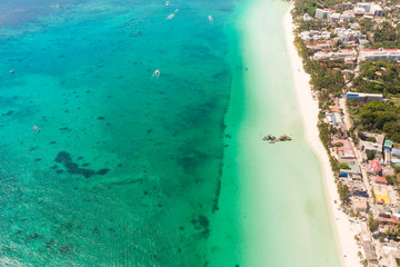 Beautiful lagoon with boats and tourist beach. White beach on the island of Boracay, top view. Seascape in sunny weather.