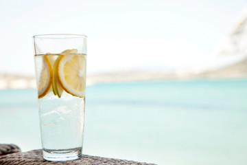 Detox Water Infused with Sliced Lemon, Cucumber and Sprigs of Mint. Copy Space on the Right.